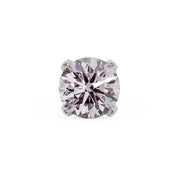 Close-up of 2mm pink diamond in four-prong white gold setting, showing faceted brilliance