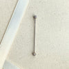 Diamond pavé straight barbell shown on linen fabric for size reference, full length visible