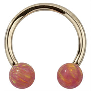 14k yellow gold circular barbell with pink opal balls, front view showing iridescent swirl detail