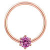 Close-up front view of 14k rose gold captive ring highlighting pink CZ prong setting and band finish