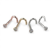 Diamond bezel nose stud twist style in all four metals: rose gold, yellow gold, platinum, white gold