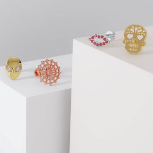 14K yellow gold sugar skull labret displayed alongside other gold flat back earring styles for comparison