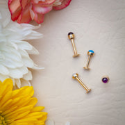 14k gold amethyst and turquoise cabochon flat back labrets arranged in floral flatlay showing full post length