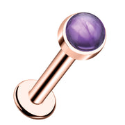 14k rose gold flat back labret with 3mm amethyst cabochon in bezel setting, angled front view