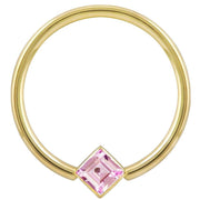 14k yellow gold fixed bead ring with pink princess-cut CZ in corner-mount bezel, front view