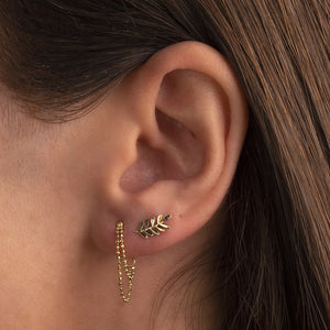 14K gold olive branch leaf flat back earring worn in left ear cartilage piercing, styled with chain earring