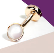 Angled close-up of 14k rose gold pearl bezel curved barbell showing bezel setting detail