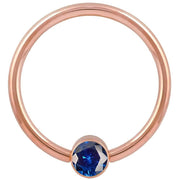 14k rose gold blue cubic zirconia bezel fixed bead ring, front view showing warm pink-gold hoop tone