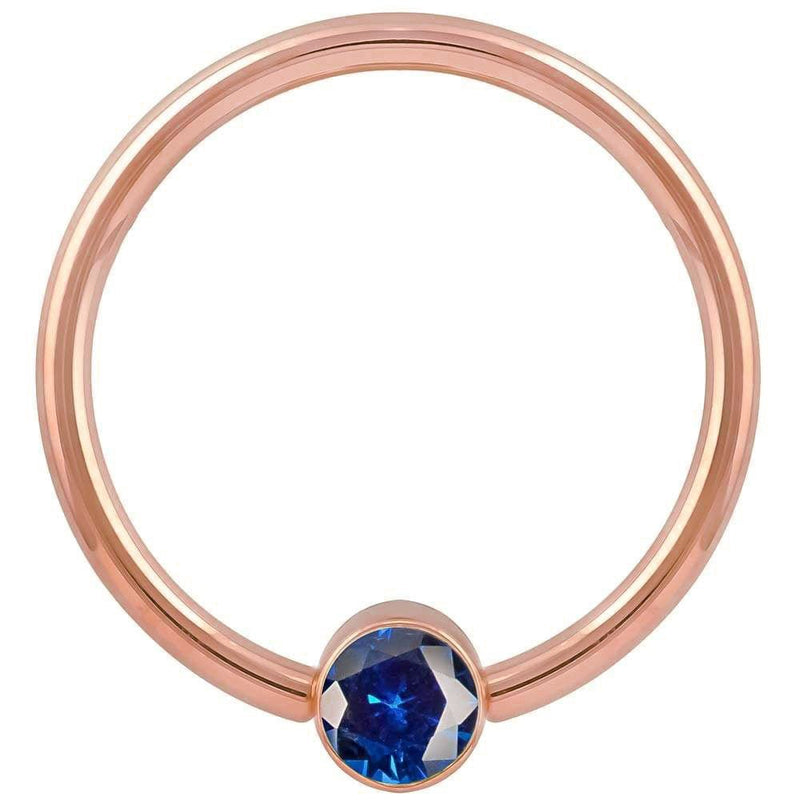 14k rose gold blue cubic zirconia bezel fixed bead ring, front view showing warm pink-gold hoop tone