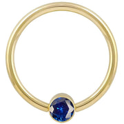 14k yellow gold blue cubic zirconia bezel fixed bead ring, straight-on front view showing polished hoop