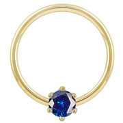 14k yellow gold fixed bead ring with deep blue round CZ in prong setting, front view