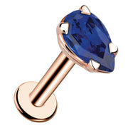 14k rose gold pear-cut blue sapphire flat back labret stud, angled view showing prong setting and flat disc back