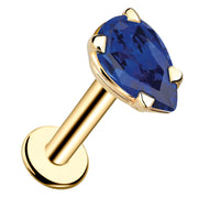 14k yellow gold pear-cut blue sapphire flat back labret stud, angled view showing prong setting and post