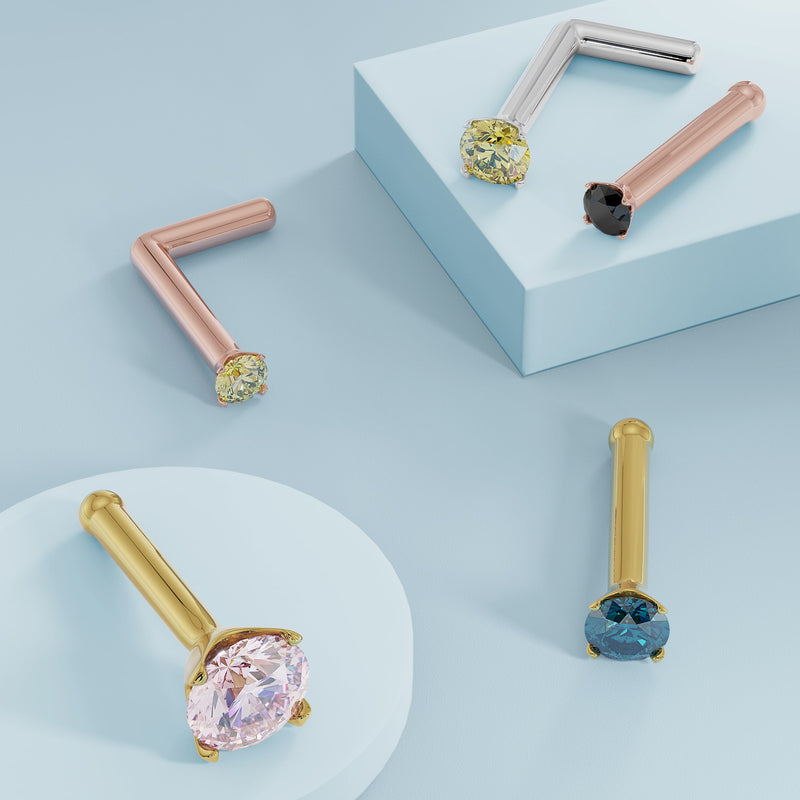 Assorted colored diamond prong nose ring studs in rose gold, white gold, and yellow gold styles