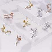 Zodiac constellation flat back earrings in yellow gold, white gold, and rose gold displayed on white blocks