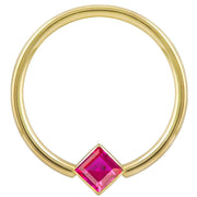 14k yellow gold fixed bead ring with red princess-cut CZ in corner-mount bezel, front view