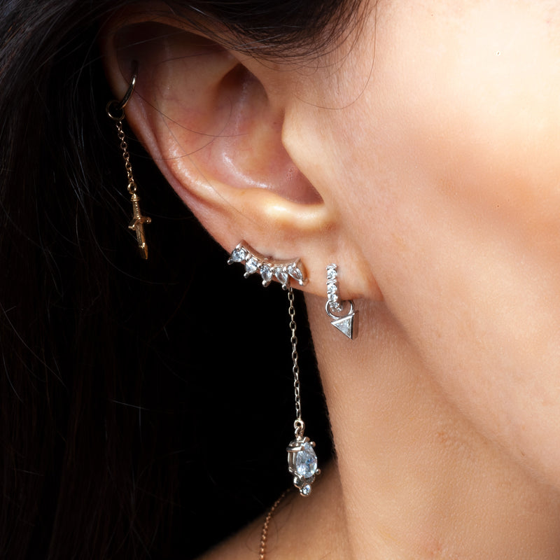 14k gold white sapphire crescent climber styled in multi-piercing ear stack with dangle earrings