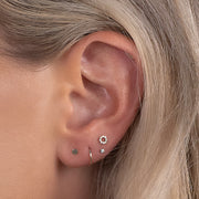 CZ halo flat back earring shown in a curated ear stack with multiple lobe piercings on model
