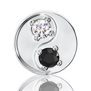 Close-up front view of 14k white gold yin yang stud highlighting prong-set black and white diamonds