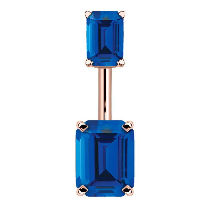 14k rose gold belly ring with double emerald-cut sapphire blue CZ stones in four-prong settings, front view