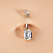Double emerald-cut clear CZ 14k gold belly ring shown in pierced navel for fit and scale reference