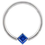 14k white gold fixed bead ring with blue princess-cut CZ in corner bezel mount, front view