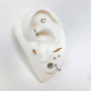 Platinum plain clicker hoop on ear display model styled with mixed metal cartilage jewelry