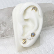 14k gold diamond moon stud in helix piercing on ear display, shown in a celestial-themed stack