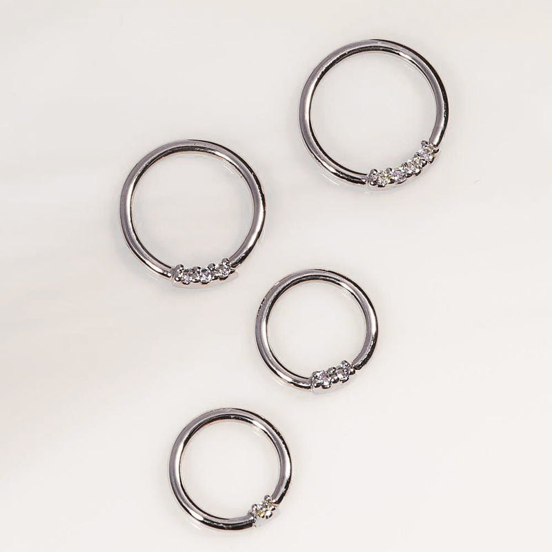 14K white gold diamond seamless hoop rings in four sizes laid flat, showing prong-set diamond detail