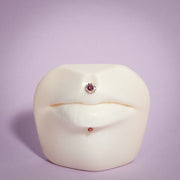 14K rose gold ball labret stud shown in labret piercing below lip on white face display model