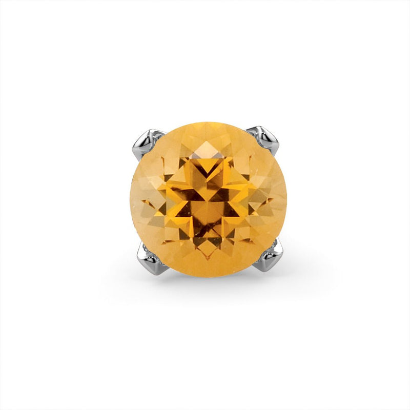 Close-up of genuine citrine round gemstone in four-prong setting, white gold prongs