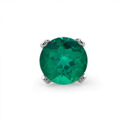 Close-up of genuine emerald in four-prong white gold setting, front-facing stone detail view