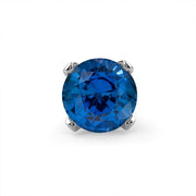 Close-up of genuine blue sapphire in four-prong setting, front view showing deep blue faceted stone