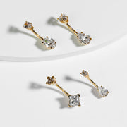 Three 14k yellow gold belly rings with varied CZ gem shapes displayed together for style comparison