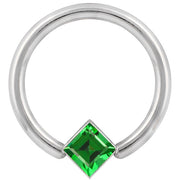Close-up front view of white gold fixed bead ring highlighting the green princess-cut CZ corner mount