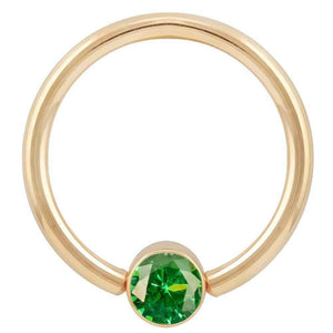 14k yellow gold fixed bead ring with emerald green CZ bezel setting, large gauge front view