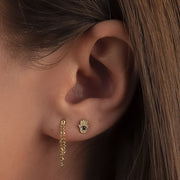 14k gold hamsa sapphire evil eye flat back earring worn in lobe piercing, styled with gold chain earring