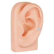 14k rose gold heart CZ cartilage stud in lobe piercing on silicone ear model, side angle view