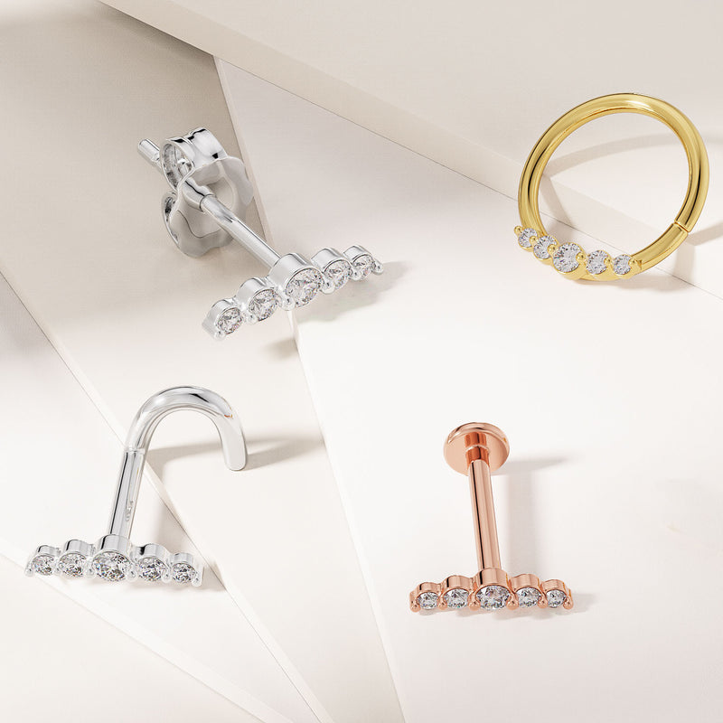14K white and rose gold CZ climber flat backs alongside yellow gold CZ ring, all three metal colors