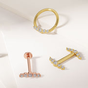 14K gold CZ climber barbell styled with matching rose gold labret and yellow gold hoop jewelry