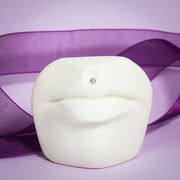 3mm pearl bezel-set flat back labret shown in philtrum piercing on white lip display prop