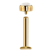 Exploded view of 14k gold pearl flat back labret showing threaded gem end separated from barbell post