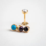 14k yellow gold 3mm pearl flat back stud upright, shown beside turquoise and amethyst cabochon variants