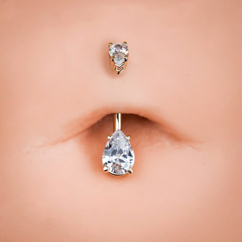 Clear CZ pear-shape 14k gold belly ring shown in pierced navel for fit and size reference