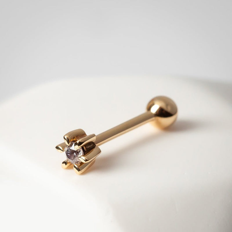 14k yellow gold diamond flower helix stud angled on ceramic prop showing petal setting and barbell