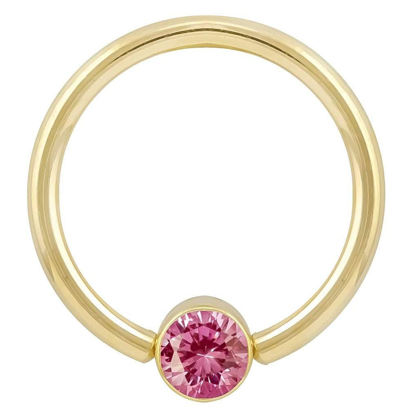 14k yellow gold fixed bead ring with bright pink round-cut CZ in bezel setting, front view