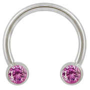 14k white gold circular barbell with pink cubic zirconia bezel ends, front view on white background