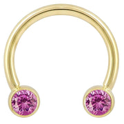 14k yellow gold circular barbell with dual pink CZ bezel ends, front view on white background