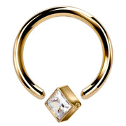 14k yellow gold fixed bead ring with clear princess-cut CZ, angled view showing open bead closure