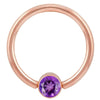 14k rose gold purple CZ fixed bead ring, larger gauge showing warm tone contrast with purple stone